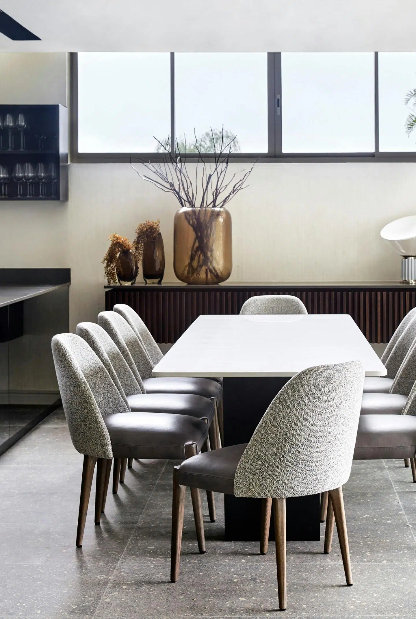 A modern dining room with grey dining chairs and a sleek dining table.